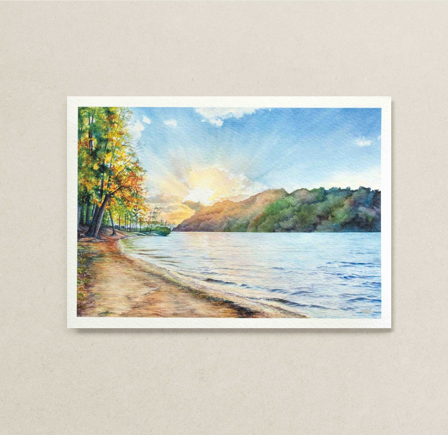 7" x 5" Art print of a watercolor landscape of Cheat Lake, WV with trees, water, and sky on a beige wall.
