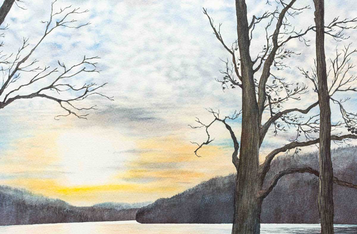 Winter landscape with details of bare trees and a sunset over Cheat Lake. 