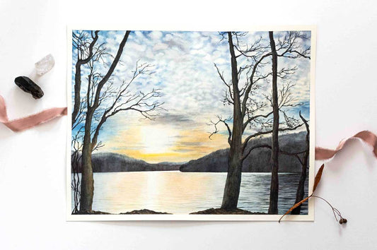Painting of a sunset over Cheat Lake with bare trees with ribbon and rocks.