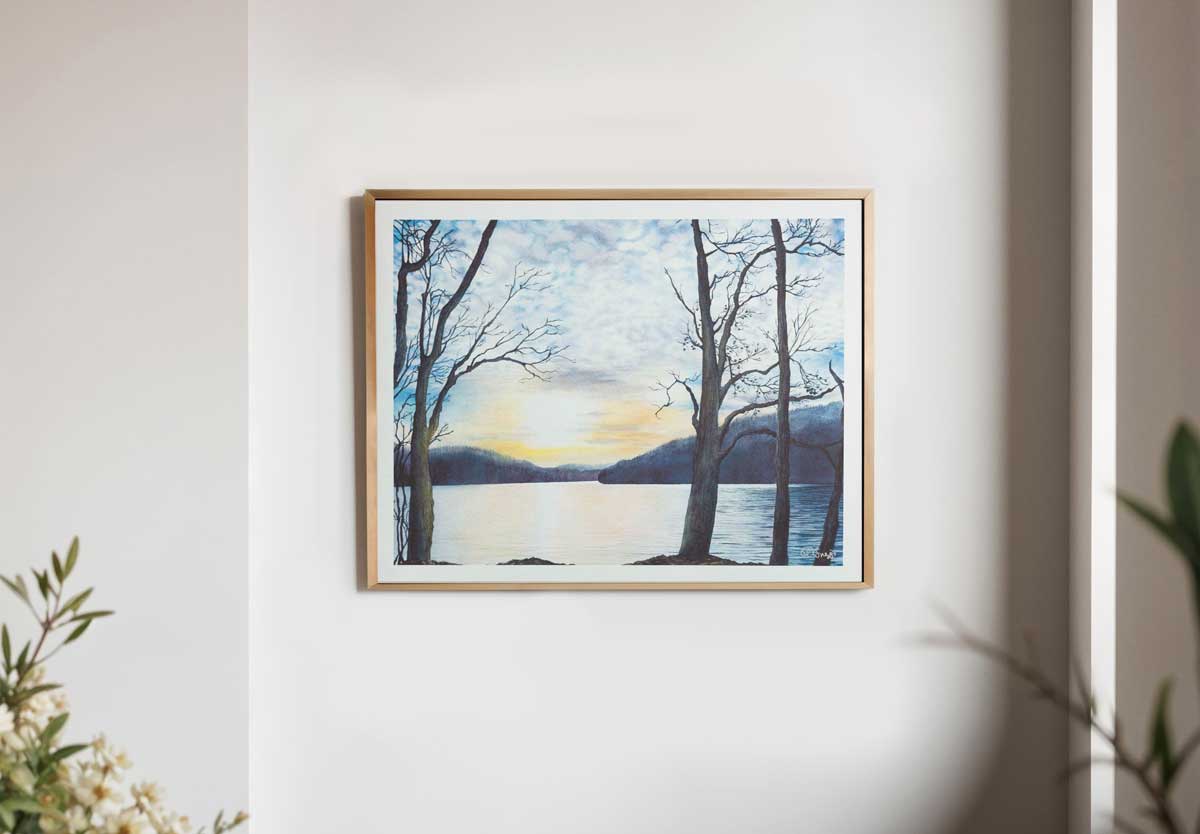 Framed artwork of Cheat Lake, West Virginia with trees and water on a white wall.