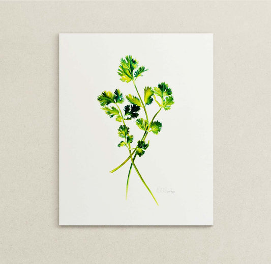 A vertical watercolor painting print featuring green cilantro stems and leaves, displayed against a neutral beige textured wall.